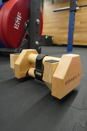 A pair of wooden travel parallettes in the gym
