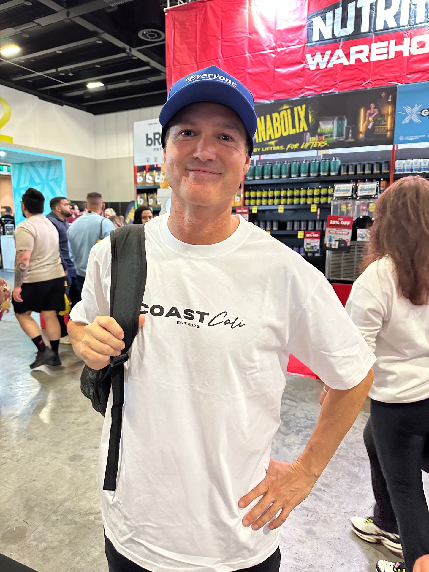 A man wearing a crew neck tee with the logo 'Coast Cali'