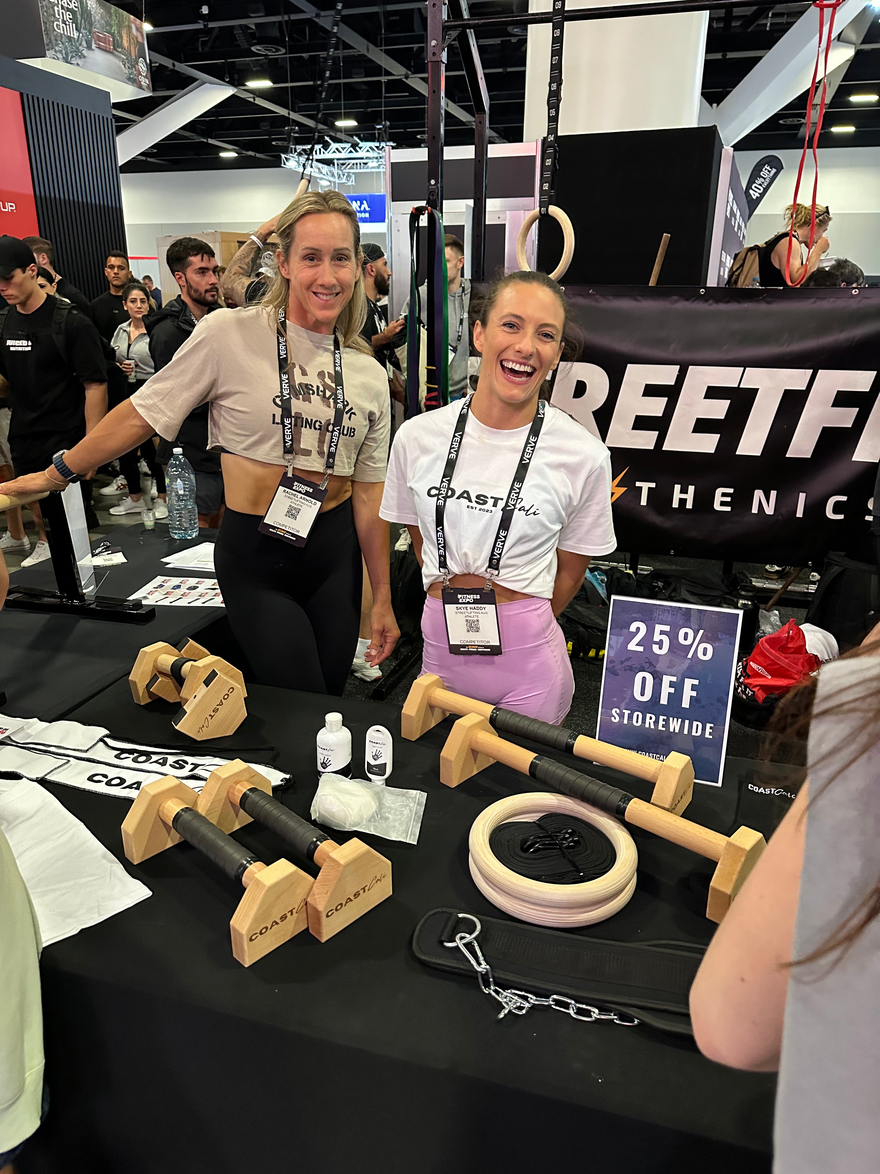 A woman wearing a white crew neck tee at a fitness expo