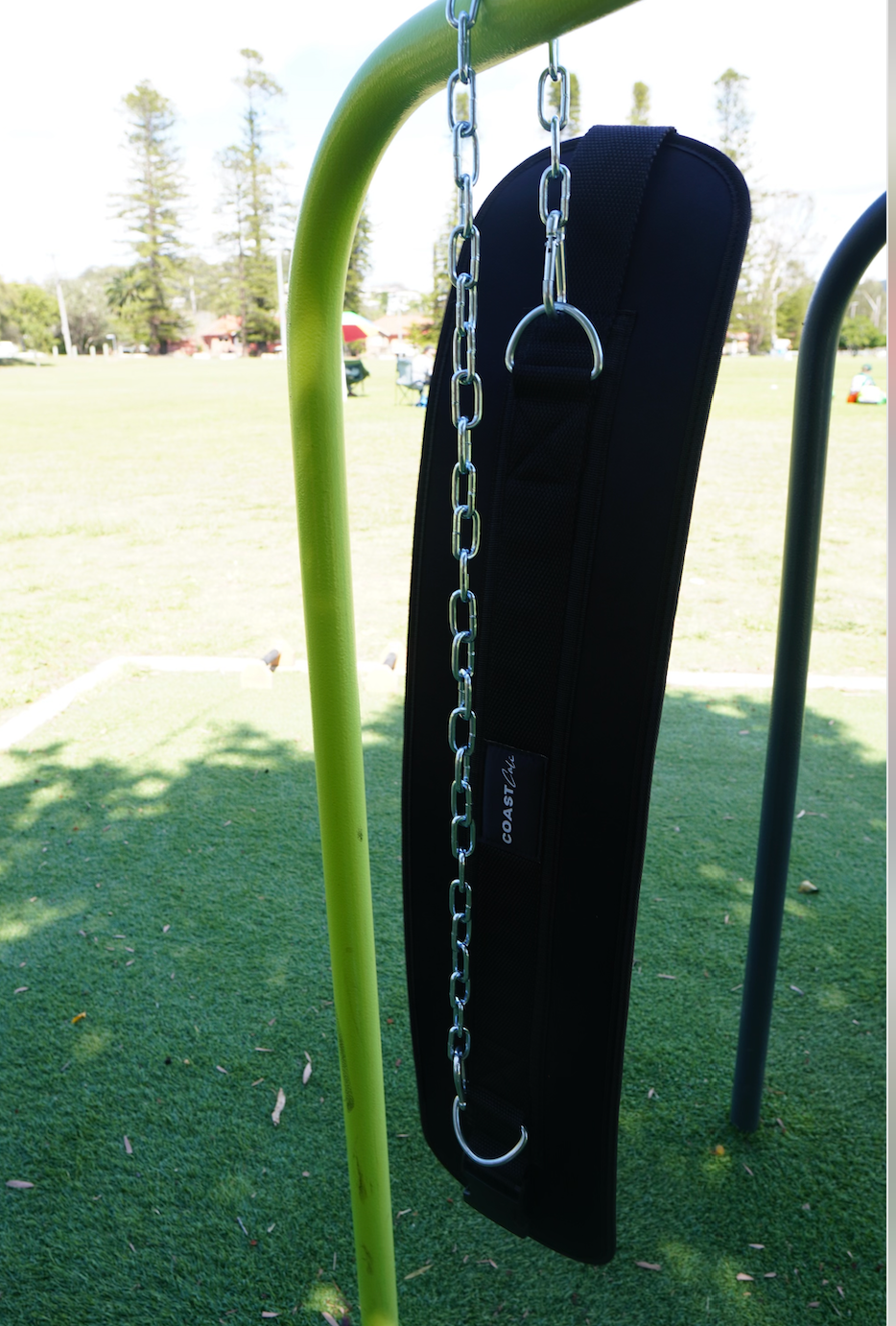 A black dip belt with a premium buckle and an adjustable steel chain attached to it.