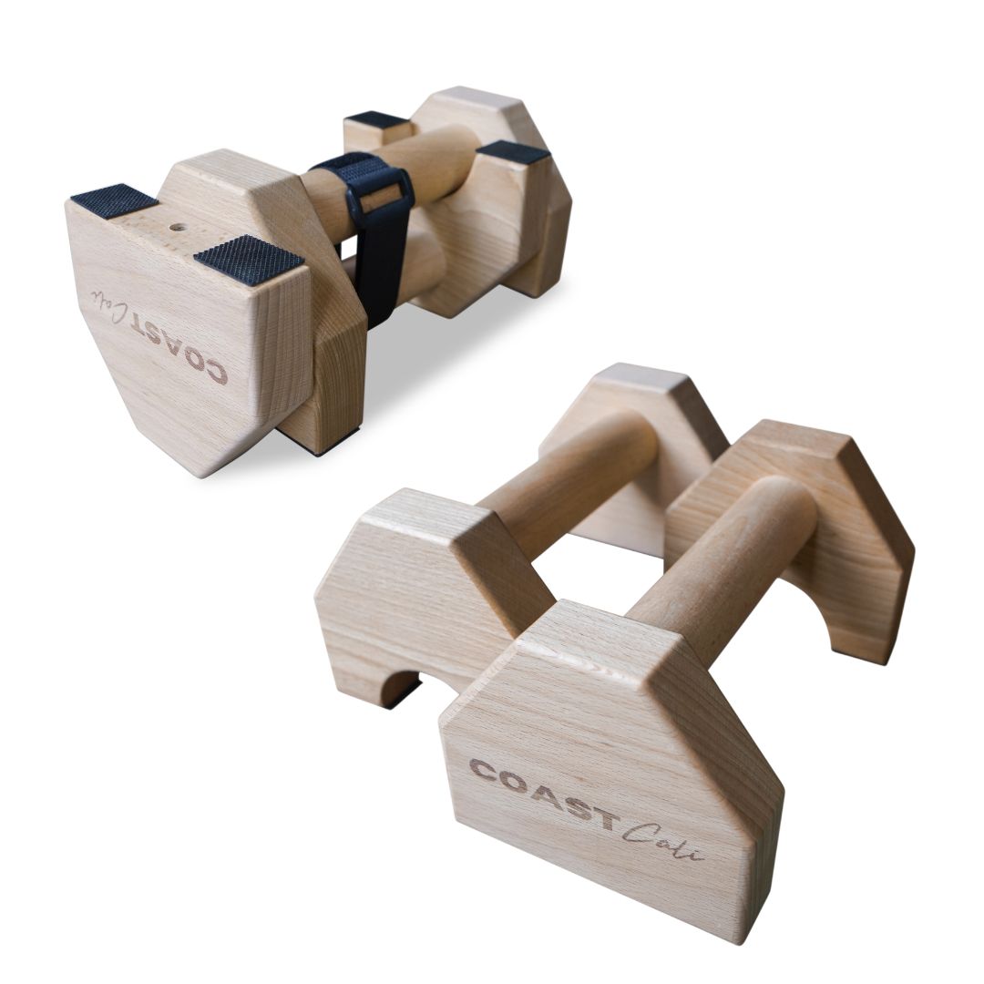 A pair of wooden travel parallettes on white background