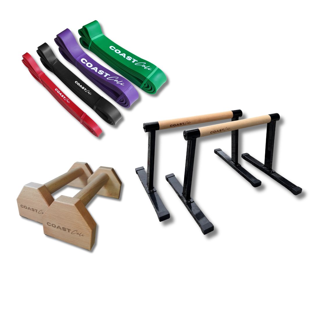 Set of exercise equipment including resistance bands and parallettes on a white background