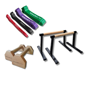 Set of exercise equipment including resistance bands and parallettes on a white background