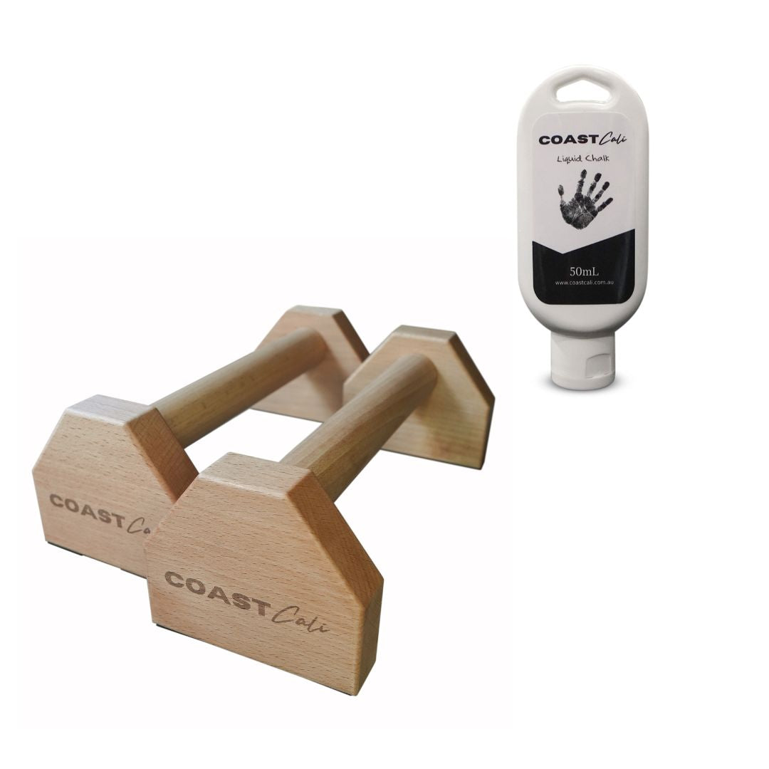 A set of wooden hand grips next to a bottle of liquid chalk, part of the Cali Starter Pack.