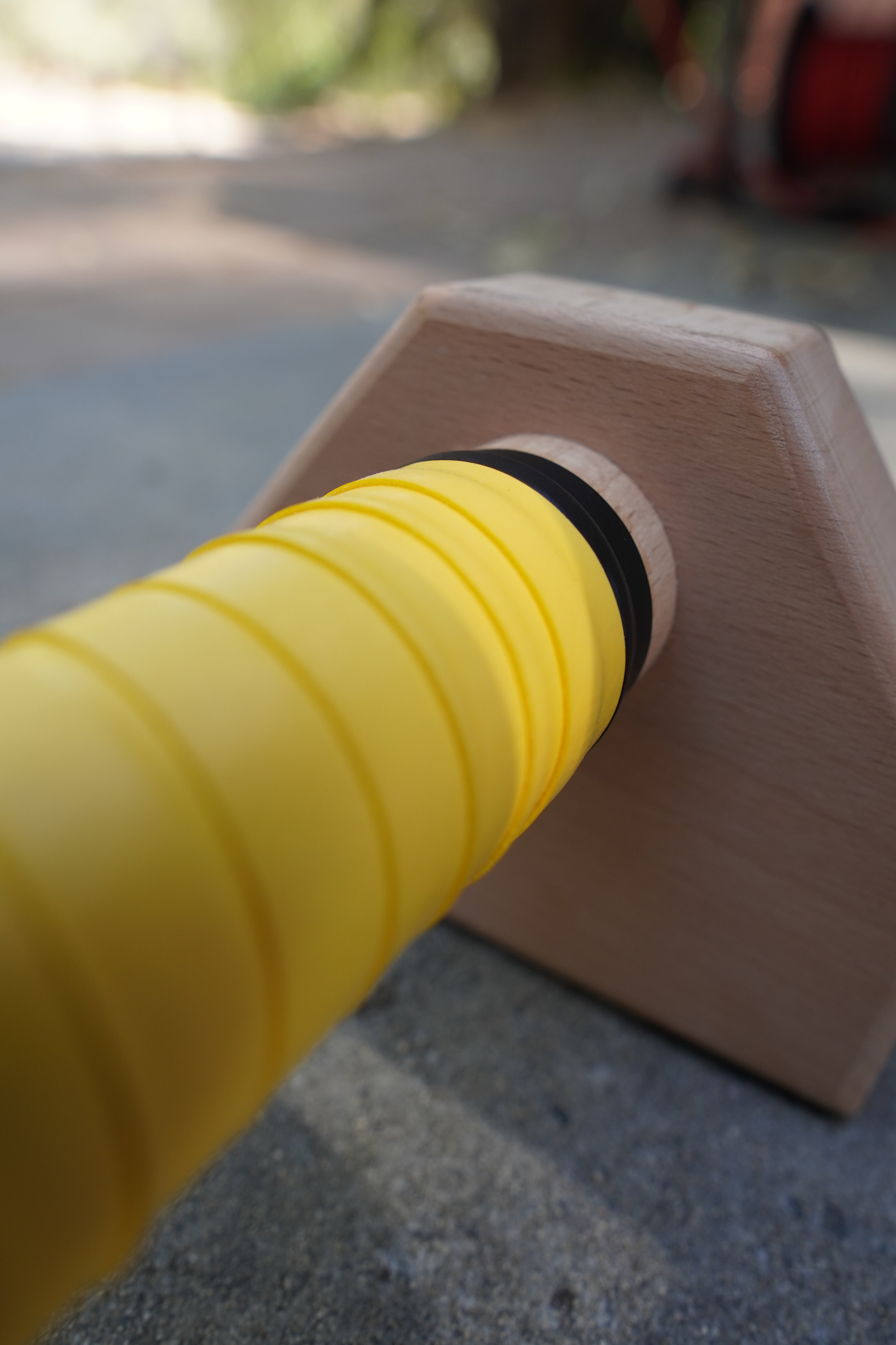 A close up of yellow grip tape on parallettes