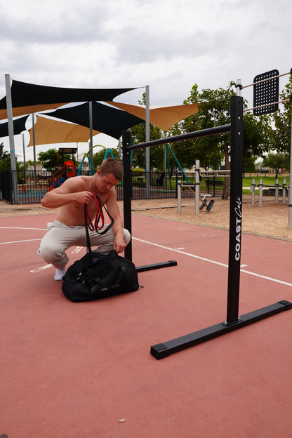 Man packing away some resistance bands into a bag
