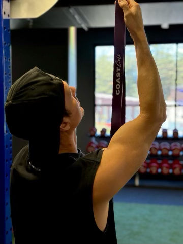 A man looking at a resistance band