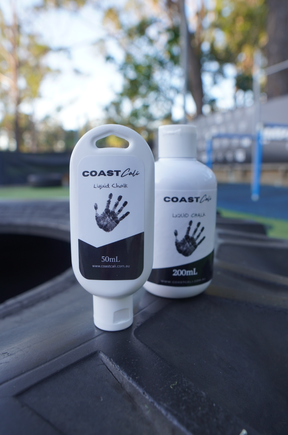 A close up of a 200ml & 50ml liquid chalk on an exercise tyre