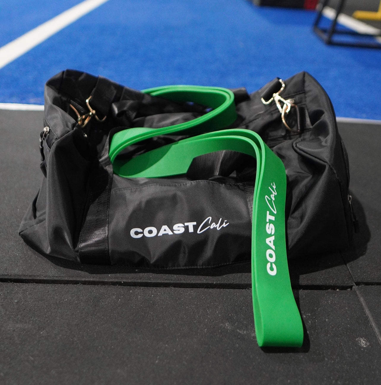 A green resistance band on a duffle bag