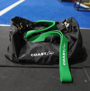 A green resistance band on a duffle bag